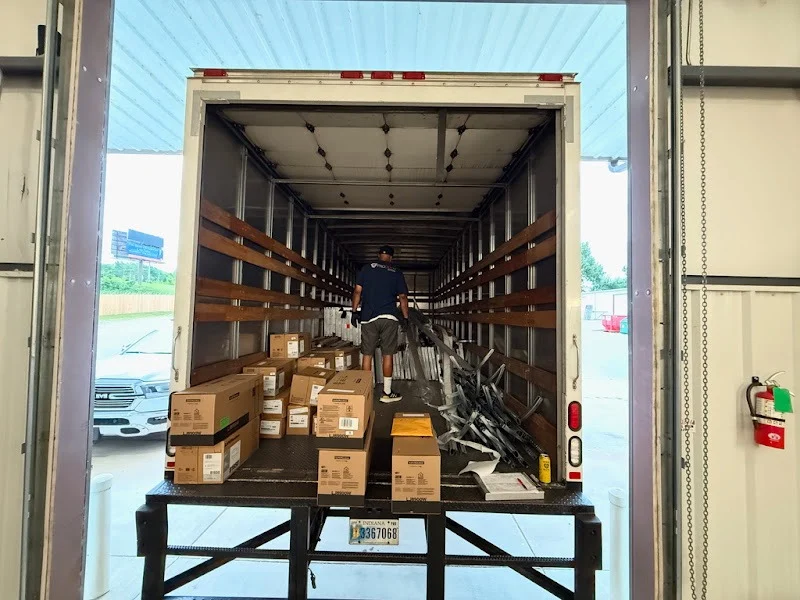 Elite Garage Door Services of Northwest ArkansasA technician loads boxes of garage door springs into a truck at a warehouse in Northwest Arkansas, emphasizing reliable local garage door service.