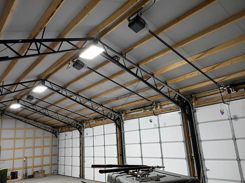 Elite Garage Door Services of Northwest ArkansasSpacious garage interior in Northwest Arkansas with multiple overhead garage doors and openers, showcasing a professional setup ready for garage door service or repair.