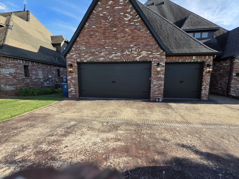 Elite Garage Door Services of Northwest ArkansasA brick house in Northwest Arkansas features two large, dark residential garage doors. The neat driveway leads to a well-maintained lawn, showcasing reliable garage door…