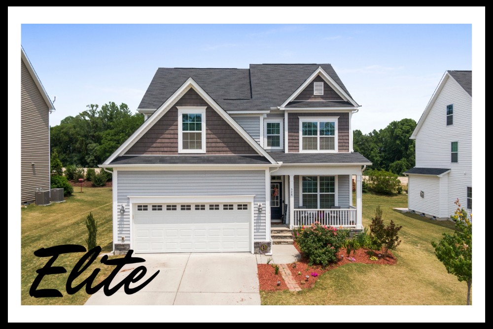 Garage Door Replacement vs Repair-1 Elite Garage Door Services of Northwest Arkansas-A charming two-story home with a white residential garage door and well-maintained lawn in Rogers AR, showcasing the quality of local garage door installation and service in Northwest Arkansas.
