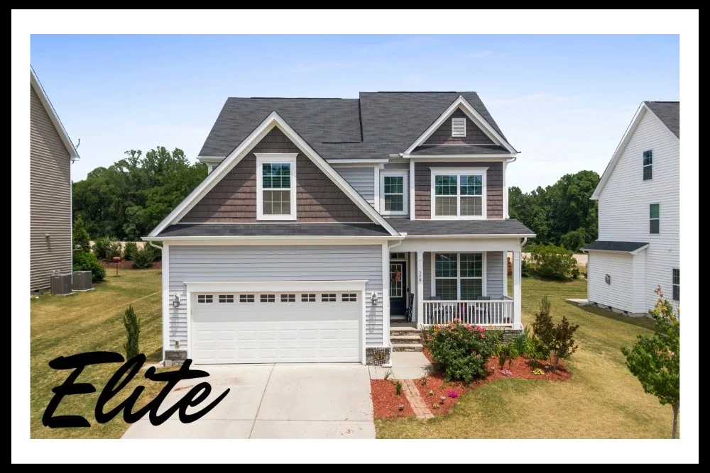 Garage Door Replacement vs Repair-1 Elite Garage Door Services of Northwest Arkansas-A charming two-story home with a white residential garage door and well-maintained lawn in Rogers AR, showcasing the quality of local garage door installation and service in Northwest Arkansas.