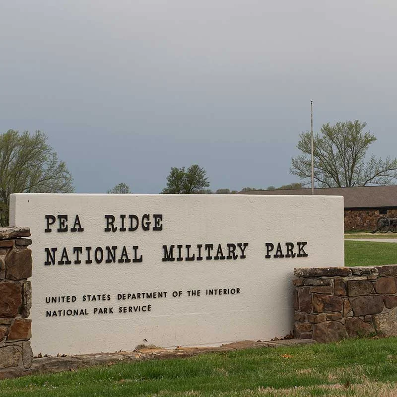 Elite Garage Door Services of Northwest Arkansas-A sign for Pea Ridge National Military Park, located in Northwest Arkansas, near Fayetteville AR, surrounded by greenery. This area is served by professional garage door service providers for local residents.