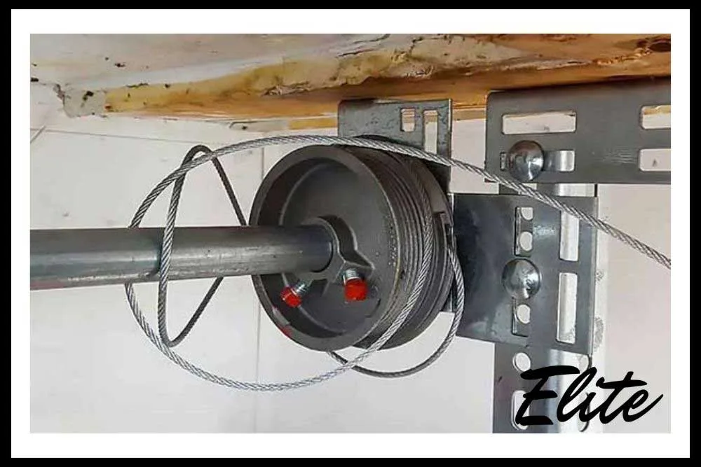 Close up of garage door rollers tracks and panels showing common wear in NWA homes