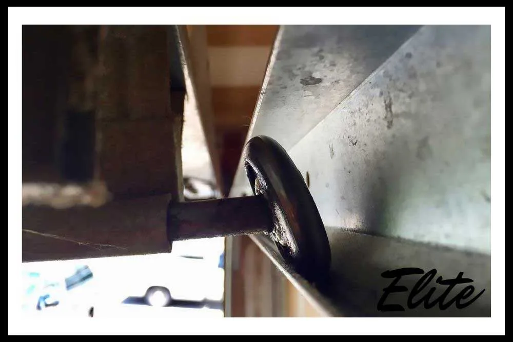 Elite Garage Door technician performing maintenance to prevent common repairs in Northwest Arkansas