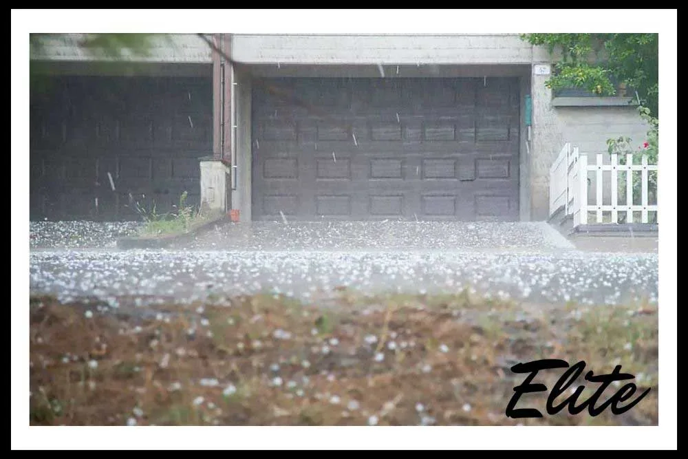 What-to-Do-When-A-Storm-Damages-Your-Garage-Door-3 Technician checking garage door opener and springs for hidden storm damage in NWA
